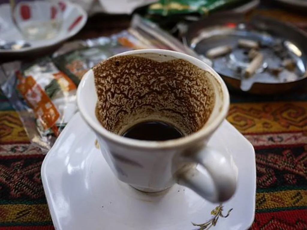 Immigrant Pretends To Enjoy Gritty, Sludgy Turkish Coffee