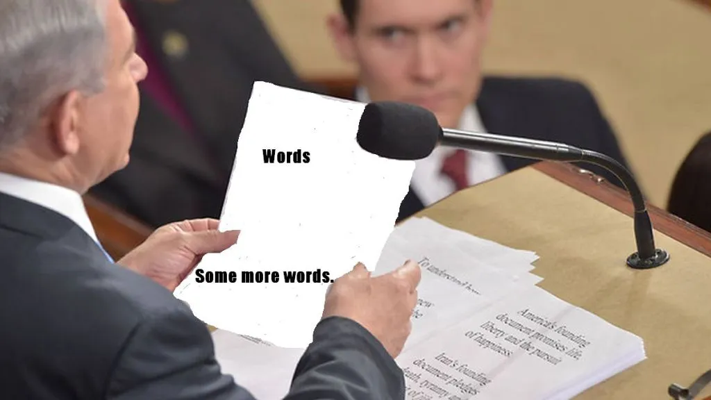 Man In Suit Addresses Other Men In Suits